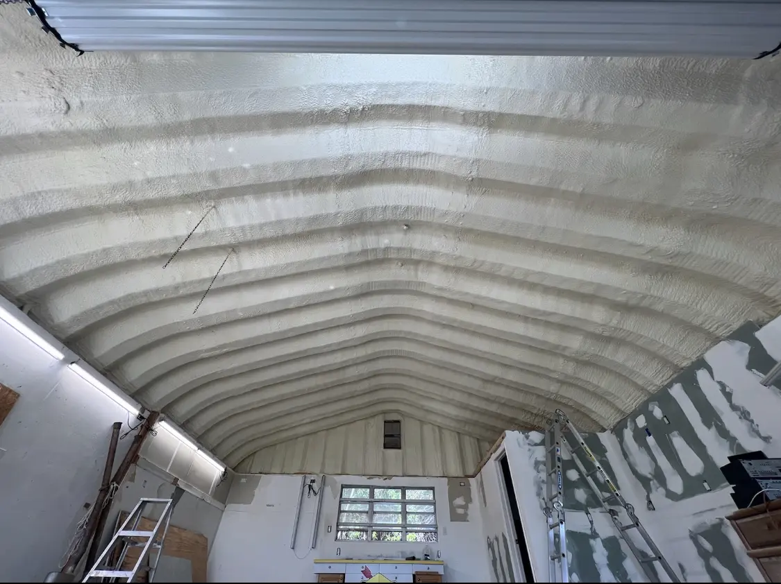 Spray polyurethane foam applied to the underside of a metal roof deck in Raymondville